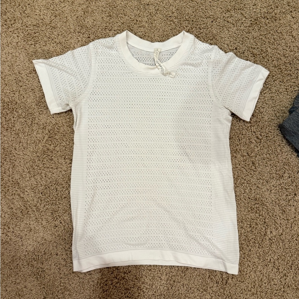 Lululemon white shirt. Tiny holes. Great for running/ warm weather